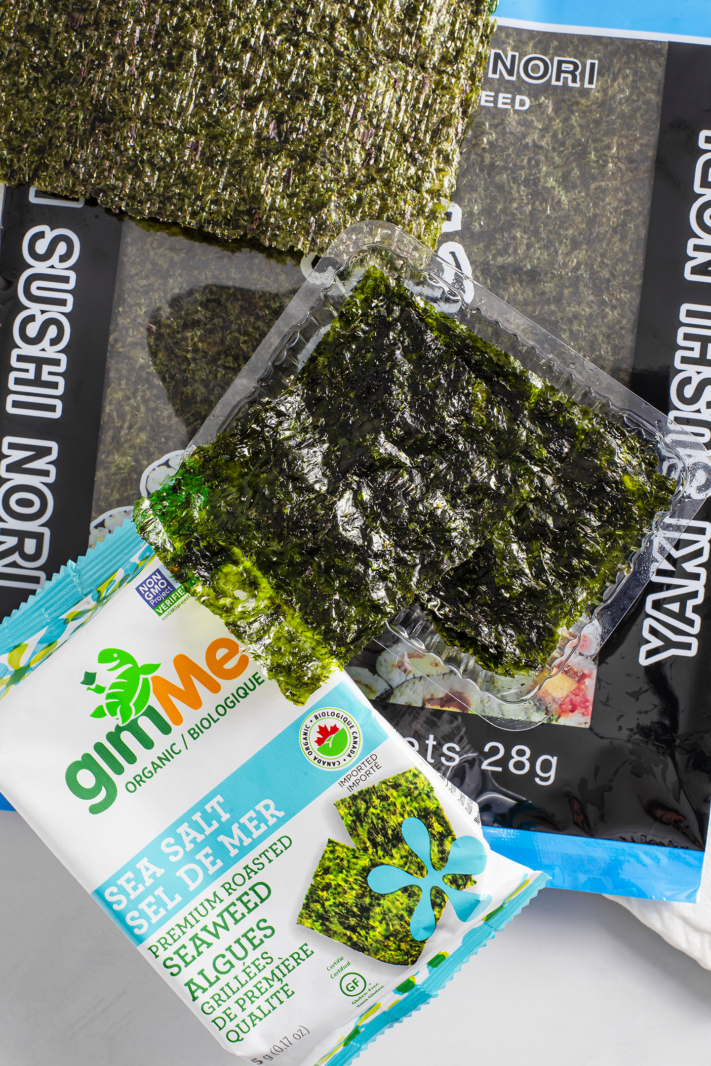 Top down view of seaweed snack sheets and large sheets of nori. 