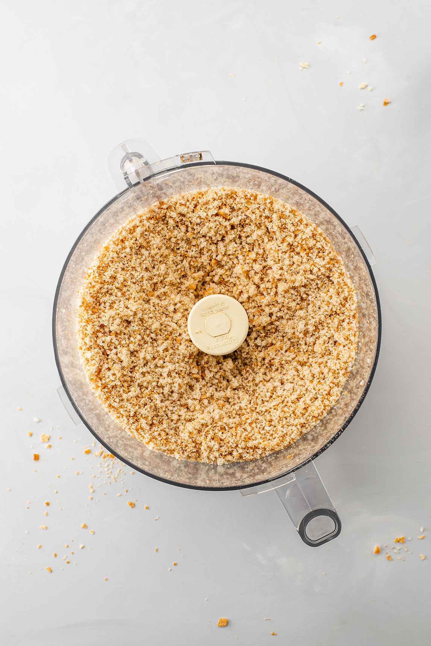 Top down view of blitzed breadcrumbs in a food processor