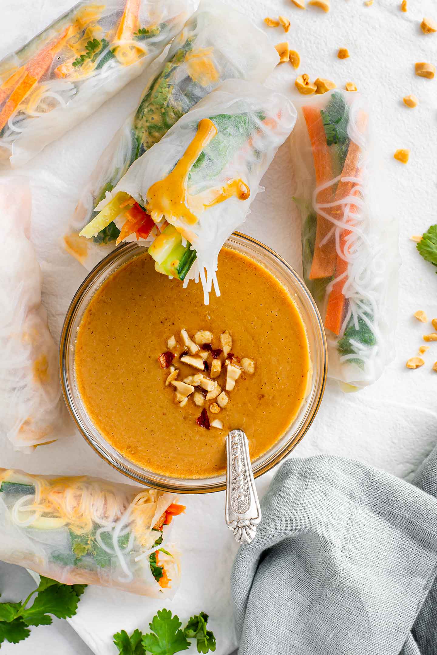 Top down view of 5 ingredient peanut sauce in the middle of rice paper spring rolls.