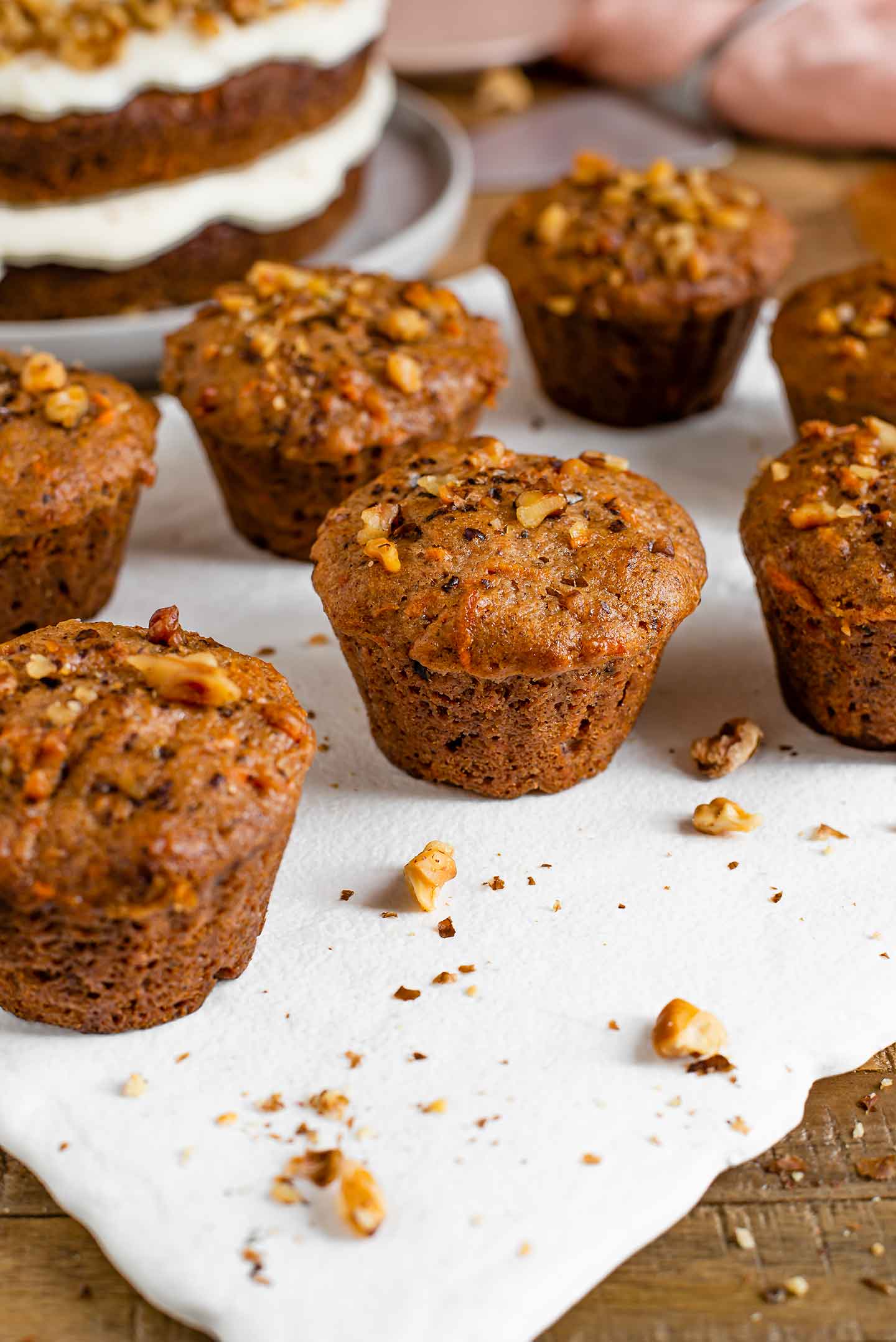 Side view of carrot muffins with a crushed walnut topping.