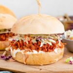 A saucy BBQ pulled jackfruit sandwich with creamy coleslaw.