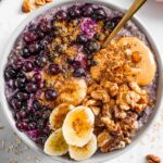 Top down view of blueberry banana oatmeal loaded with toppings.