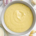 Top down view of dairy-free bechamel sauce filling a bowl.