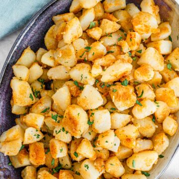 Top down view of small cut vegan home fries in a serving dish.
