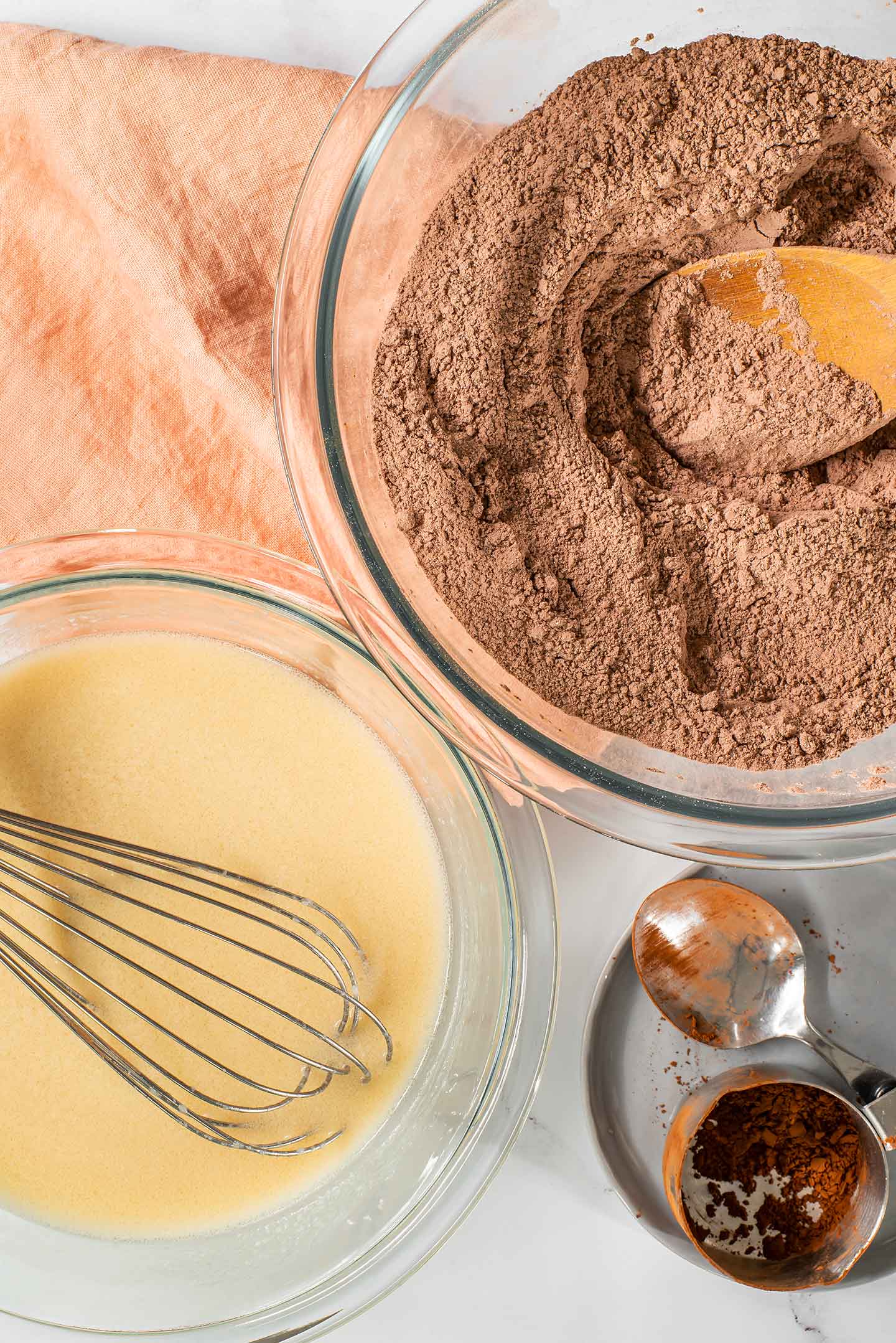 Top down view of separated wet and dry ingredients for the chocolate cake.