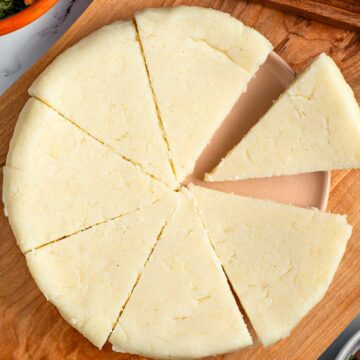 Top down view of pie shaped slices of Kenyan ugali. The cornmeal is firm, smooth, and white.