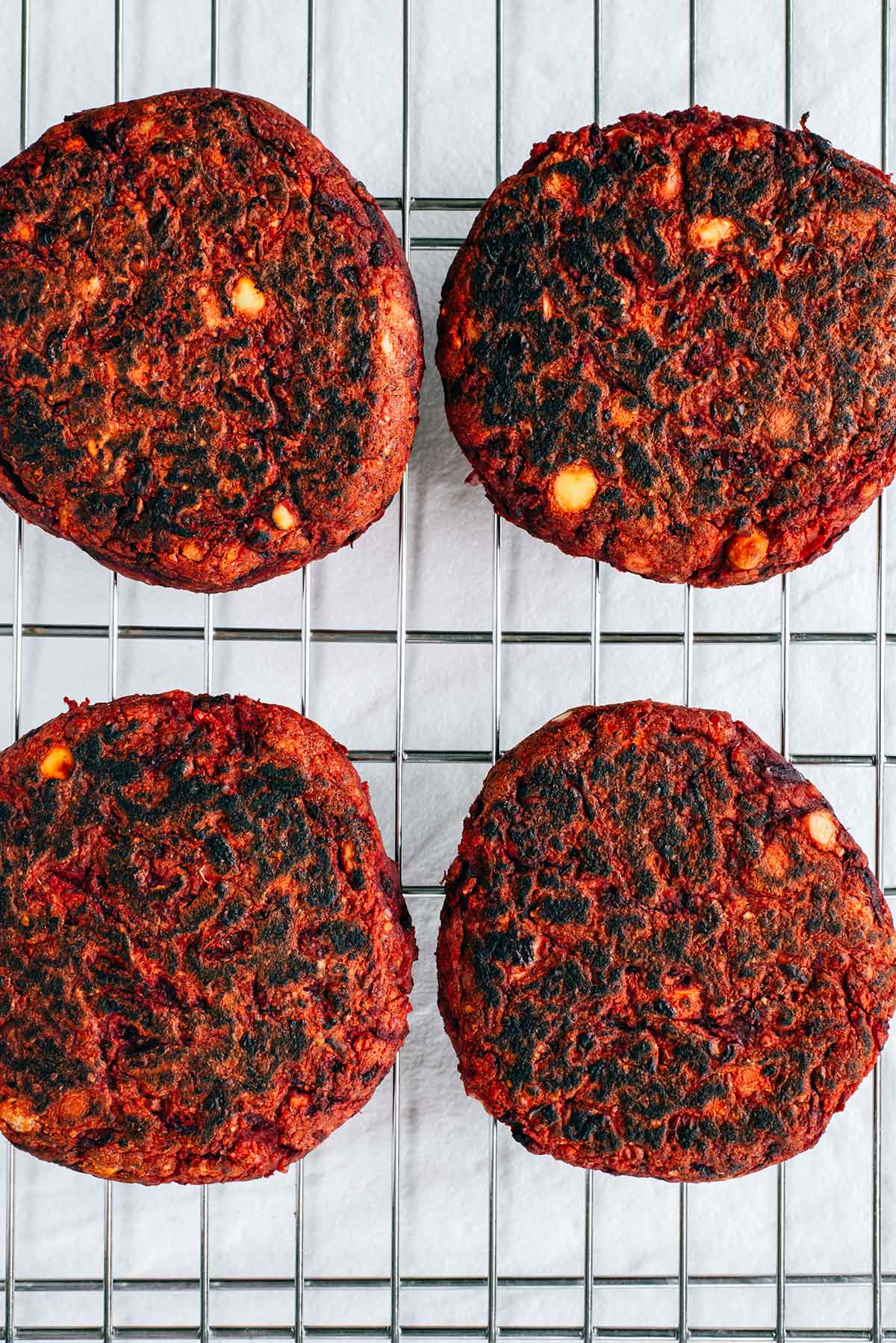 Top down view of pan seared beet burgers. The burgers are crispy and slightly blackened on the outside.